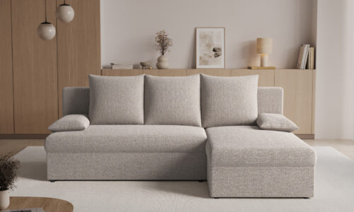 Light grey L-shaped sofa in a minimalist living room with wooden cabinets and neutral decor.